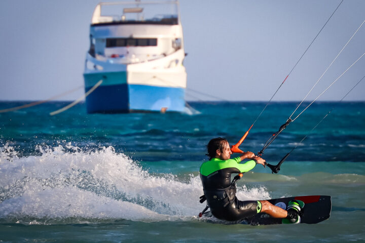 Kiter riding in front of the boat
