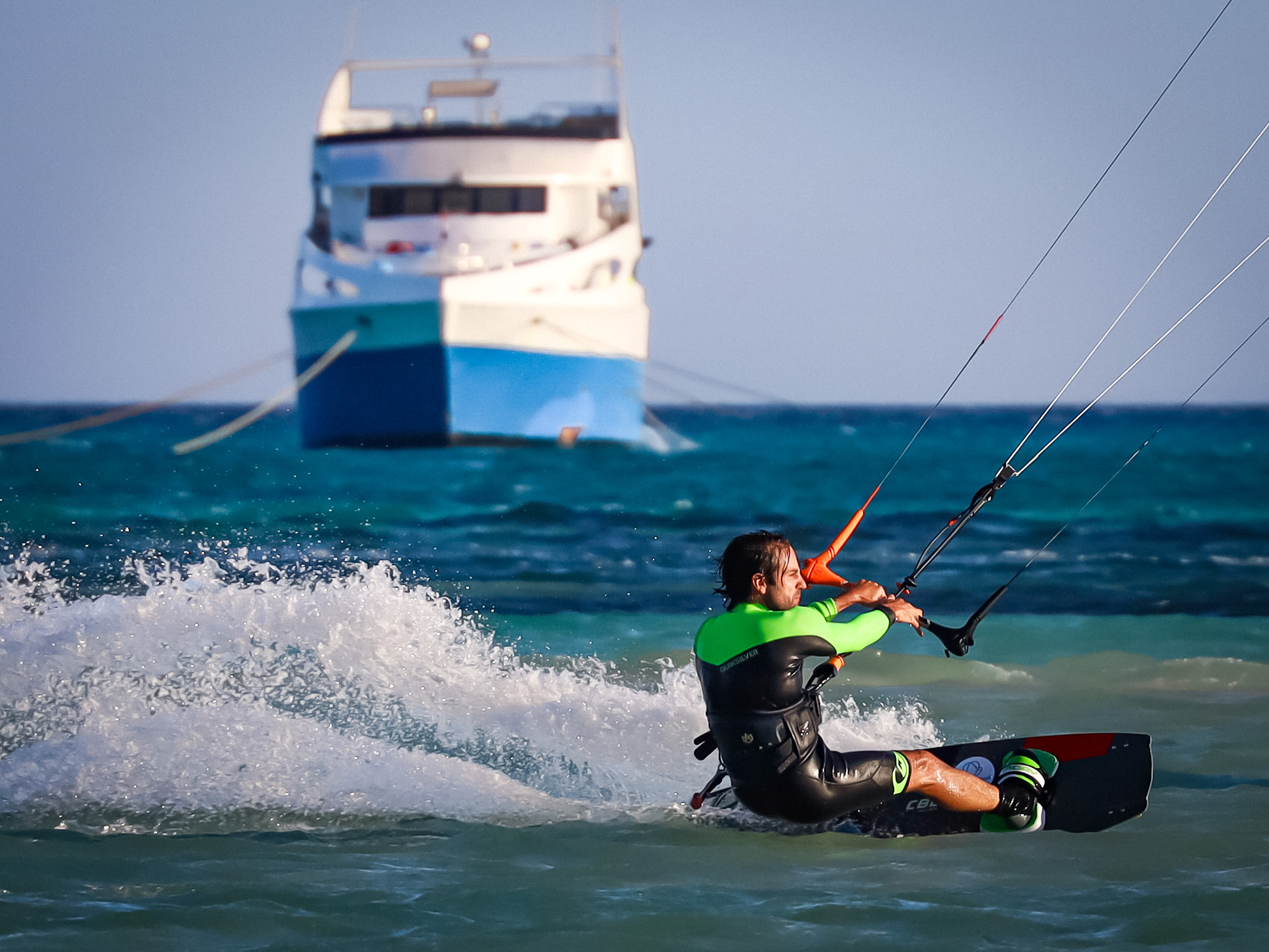 Kiter riding in front of the boat
